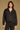 Model wearing the Saltwater Luxe Lorian Hoodie in Black with subtle star embroidery, front view
