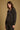 Model wearing the Saltwater Luxe Lorian Hoodie in Black with subtle star embroidery, side view