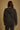 Model wearing the Saltwater Luxe Lorian Hoodie in Black with subtle star embroidery, back view