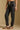 Model wearing the Saltwater Luxe Elara Black Pant with a relaxed tapered leg, side view