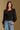 Model wearing the Saltwater Luxe Briella Black Top with a square neckline, gathered sleeves and fitted bodice, front view