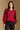 Model wearing the Saltwater Luxe Briella Crimson Top with gathered long sleeves and a back tie detail, front view