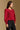 Model wearing the Saltwater Luxe Briella Crimson Top with gathered long sleeves and a back tie detail, side view