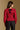 Model wearing the Saltwater Luxe Briella Crimson Top with gathered long sleeves and a back tie detail, back view