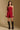 Model wearing the Saltwater Luxe Riven Mini Dress in Crimson with slim straps, side view