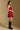 Model wearing the Saltwater Luxe Riven Mini Dress in Crimson with slim straps, back view