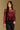 Model wearing the Saltwater Luxe Korrey Burgundy Top with a ruffled hem, front view