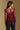 Model wearing the Saltwater Luxe Korrey Burgundy Top with a ruffled hem, back view