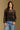 Model wearing the Saltwater Luxe Korrey Black Top with a ruffled hem, front view