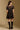 Model wearing the Saltwater Luxe Yaz Black Mini Dress with short puff sleeves, back view