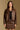 Model wearing the Saltwater Luxe Ryland Jacket in Chocolate with a pointed collar, front view