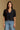 Model wearing the Saltwater Luxe Aeris Black Sweater showing black short-sleeve V-neck button-front sweater, front view
