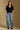 Model wearing the Saltwater Luxe Aeris Black Sweater showing black short-sleeve V-neck button-front sweater, full-body view
