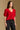 Model wearing the Saltwater Luxe Aeris Crimson Sweater showing crimson short-sleeve V-neck button-front sweater, side view