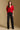 Model wearing the Saltwater Luxe Aeris Crimson Sweater showing crimson short-sleeve V-neck button-front sweater, full-body view