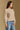 Model wearing the Saltwater Luxe Marri Natural Sweater with a softly textured knit, side view