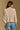 Model wearing the Saltwater Luxe Marri Natural Sweater with a softly textured knit, back view