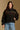 Model wearing the Saltwater Luxe Orian Black Jacket with small allover motifs, front view