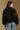 Model wearing the Saltwater Luxe Orian Black Jacket with small allover motifs, back view