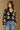 Model wearing the Saltwater Luxe Calian Sweater in Black with contrast cream flowers, front view