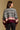 Model wearing the Saltwater Luxe Aden Bold Stripe Sweater in Multi with grey, cream and burgundy bands, back view