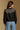 Model wearing the Saltwater Luxe Joss Black Sweater with a Fair Isle-inspired yoke, back view