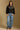 Model wearing the Saltwater Luxe Joss Black Sweater with a Fair Isle-inspired yoke, full-body view