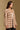 Model wearing the Saltwater Luxe Birdy Chai Sweater with wide cream horizontal stripes, side view