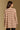 Model wearing the Saltwater Luxe Birdy Chai Sweater with wide cream horizontal stripes, back view