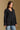 Model wearing the Saltwater Luxe Vionna Black Sweater with a textured knit, side view