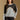 Model wearing the Saltwater Luxe Crue Vintage Blue Sweater with charcoal and cream diagonal panels, front view