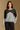 Model wearing the Saltwater Luxe Crue Vintage Blue Sweater with charcoal and cream diagonal panels, front view