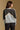 Model wearing the Saltwater Luxe Crue Vintage Blue Sweater with charcoal and cream diagonal panels, back view