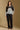 Model wearing the Saltwater Luxe Crue Vintage Blue Sweater with charcoal and cream diagonal panels, full-body view