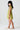 Side view of a young girl wearing the Saltwater Luxe  green Brammie Mini Dress on a white background