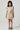 Girl model wearing Saltwater Luxe Littles Brammie Girls Mini Dress in Blue Floral front full body studio view on grey background