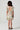 Girl model wearing Saltwater Luxe Littles Brammie Girls Mini Dress in Blue Floral back full body studio view on grey background