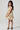 Side profile of the Girls Allima Mini Dress showcasing the flowy silhouette and floral print