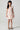 Girl model wearing Saltwater Luxe Littles Sophia Mini Dress in Cream Floral front full body studio view on grey background