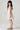 Girl model wearing Saltwater Luxe Littles Sophia Mini Dress in Cream Floral side full body studio view