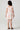 Girl model wearing Saltwater Luxe Littles Sophia Mini Dress in Cream Floral back full body studio view on grey background