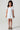 Girl model wearing Saltwater Luxe Littles Allima Girls Mini Dress in Blue Floral front full body studio view on grey background