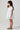 Girl model wearing Saltwater Luxe Littles Allima Girls Mini Dress in Blue Floral side full body studio view