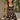 Girl model wearing Saltwater Luxe Littles Kayler Girls Mini Dress in Black Shell Print standing outdoors near lemon tree