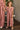 Girl wearing the Lucca Jumper in a soft pink stripe with ruffle sleeves and a relaxed wide-leg silhouette