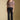 Full body front view of a woman wearing the Saltwater Luxe Robyn Top on a neutral background with black pants and sneakers