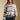 Front view of a woman wearing the Saltwater Luxe Mimi Sweater on a neutral background with black pants