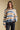 Front view of a woman wearing the Saltwater Luxe Mimi Sweater on a neutral background with black pants