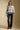 A full body front view of a woman wearing the Saltwater Luxe Mimi Sweater on a neutral background