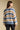 Back view of a woman wearing the Saltwater Luxe Mimi Sweater on a neutral background with pant